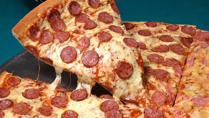 Pepperoni pizza slices with melted cheese