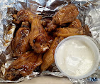 Sauced chicken wings with a side of blue cheese